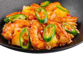 Spicy shrimps and pineapple with rice and chili pepper on black plate
