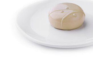 Delicious glossy mousse cake lying on white plate