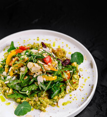 Gourmet vegetarian salad on dark background