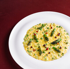 Delicious risotto with asparagus and pancetta on white plate
