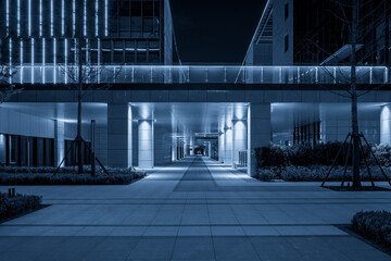 Sleek Urban Nightscape with Contemporary Architecture and Blue Lighting Effects
