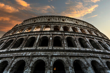 Partial perspective view of the Colosseum in Rome, Italy, at sunset.
