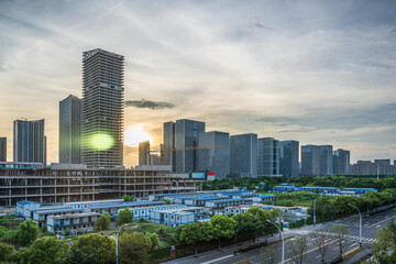 Fototapeta premium Urban Sunset: A Stunning View of Modern City Skyline and Development