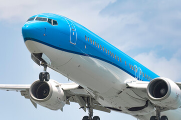 Modern passenger airplane is landing at the airport