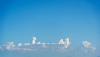 Whimsical Cloud Shapes in a Clear Blue Sky: A Serene Escape