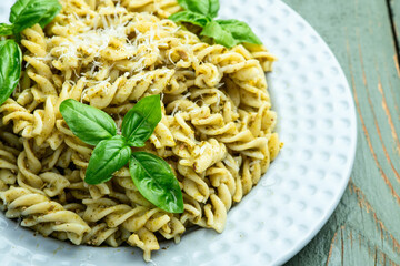 Pasta with basil sauce pesto . Italian food photography . Top view