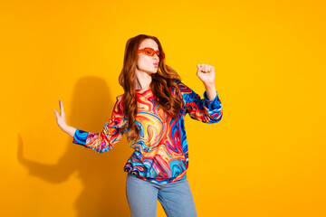 Photo of nice girl with foxy hairstyle dressed print shirt in sunglass sing in imaginary microphone isolated on yellow color background