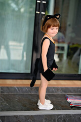 Kid girl in costume of black cat