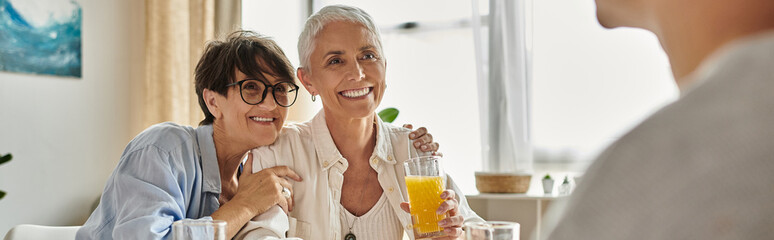 A warm breakfast gathering where two proud moms celebrate life with their smiling adult son.