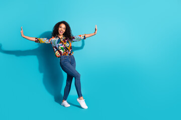 Obraz premium Photo of cheerful lovely cute woman wear trendy clothes hold empty space isolated on blue color background