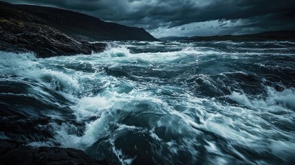 Dramatic ocean waves clash against rugged rocks under a stormy sky, creating a powerful seascape during turbulent weather.