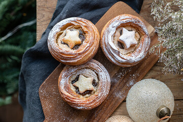 Traditional Christmas mince pies with dried fruits on a decorated table. English festive dessert.