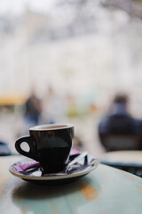 Espresso Coffee in a Small Black Cup Standing on a Table