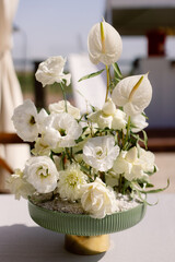 Compositions of white flowers on the festive table