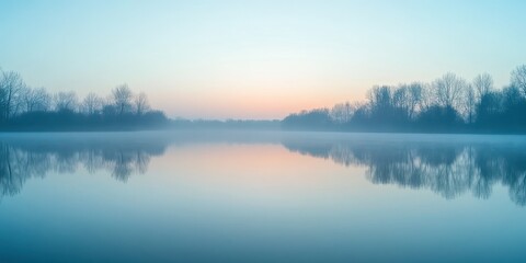 Fototapeta premium A serene landscape at dawn, showcasing calm waters reflecting the pastel colors of the sky, surrounded by misty trees.