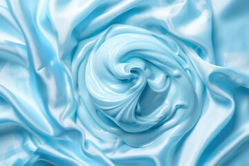 Obraz premium Swirling blue cream on silky fabric creates a smooth, artistic display