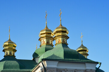 Golden Domes of the Church of the Savior on Berestov on the background of the blue sky Kyiv Ukraine