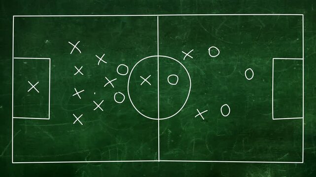 Whiteboard Soccer trainer explaining match tactics to soccer team.