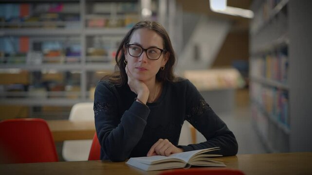 A focused reader in a calm library setting, deeply engaged with an interesting book