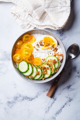 Savory cottage cheese bowl with egg, tomatoes and cucumber.