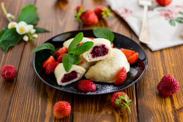 cooked sweet homemade steamed dumplings with strawberries