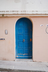 Fototapeta premium Narrow Thin Blue Arch Door with Traditional Door Knob Closing the Entry of a Home