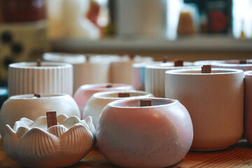 Made candle in the workshop. Process of making candles in a workshop. Ecological and vegan business. Set of aroma candles on a table.
