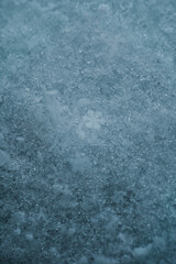 Macro picture of snow with crystals in good view. Natural snowflakes on snow. Photo of real snowflakes during a snowfall, under natural conditions at low temperature.