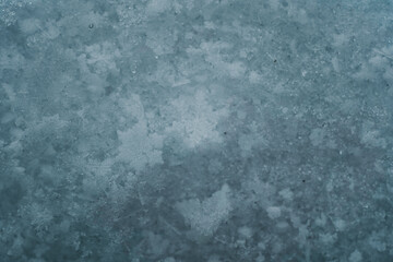 Snowflakes on snow. Christmas and winter background. Natural snowdrift close up photo. Macro picture of snowflakes with crystals in good view.