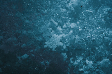 Natural snowflakes on snow. Photo of real snowflakes during a snowfall, under natural conditions at low temperature. Macro picture of snow with crystals in good view dark background.
