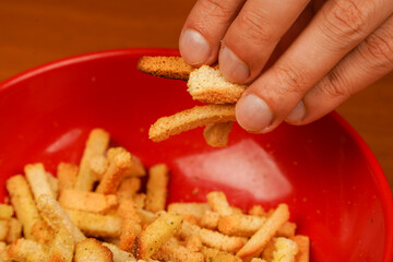 Fast carbohydrates. Salty snack for beer. Unhealthy food. Croutons. Croutons in bowl. Unhealthy food for figure, heart, skin, teeth. Junk food. Fast food. Snack. Cholesterol.