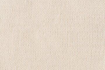 Background made of white knitted fabric. Front surface.