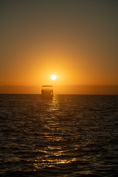 ship at sea against the backdrop of sunset
