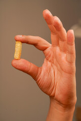 Holding crouton in hand. Snack. Cholesterol. Fast carbohydrates. Salty snack for beer. Unhealthy food. Croutons. Unhealthy food for figure, heart, skin, teeth. Junk food. Fast food.