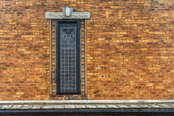 Window with wrought iron bars in brick wall