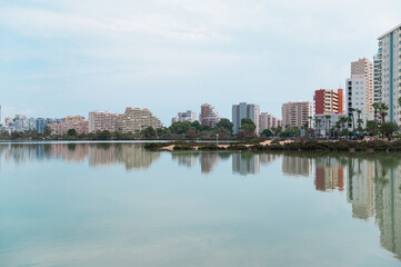 Cityscape with modern buildings reflected in calm water