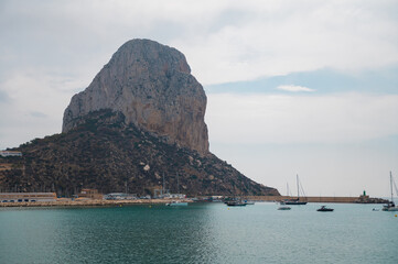 Scenic view of Penon de Ifach by the calm sea in Calpe