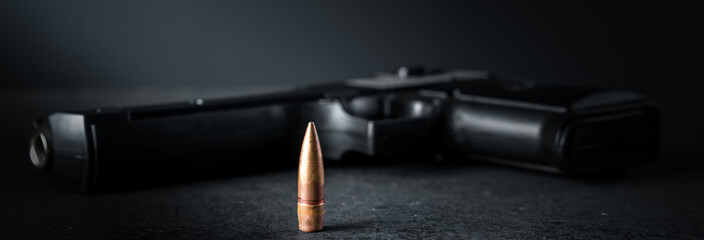 Gun bullet and gun on the table, criminal concept