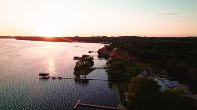 Sunset view of tranquil houses near the Green Lake Inlet Boat Launch Site in Ripon, Wisconsin, capturing the peaceful atmosphere of lakeside living as day transitions into night.