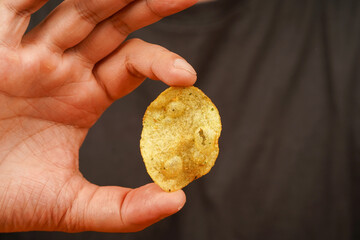 Man eating potato chips. Fast food. Unhealthy lifestyle Junk food. Hands hold potato chip....