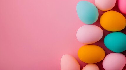 Colorful Easter eggs arranged on pink background with copy space.