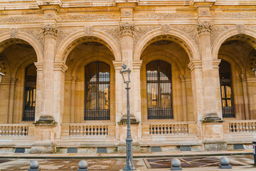 Crooked Public Street Lamp Standing infront of a Renaissance Building