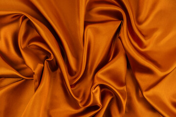 Orange fabric texture background, detail of silk or linen pattern.