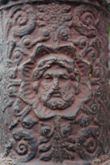 Metal Post with the Face of a Man with a Beard Embedded