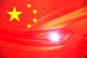 Top view of a car with the with the Chinese flag as background. Concept of cars in China or Chinese car industry.