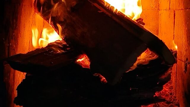 Burning firewood in a fireplace in June at a dacha