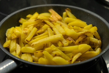 Home fried potatoes on a pan close-up. French fries