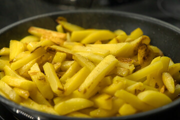 Home fried potatoes on a pan close-up. French fries