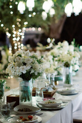 Compositions of white flowers on the festive table