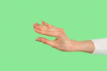 Elegant hand gesture against a bright green background showcasing expressive communication in modern art